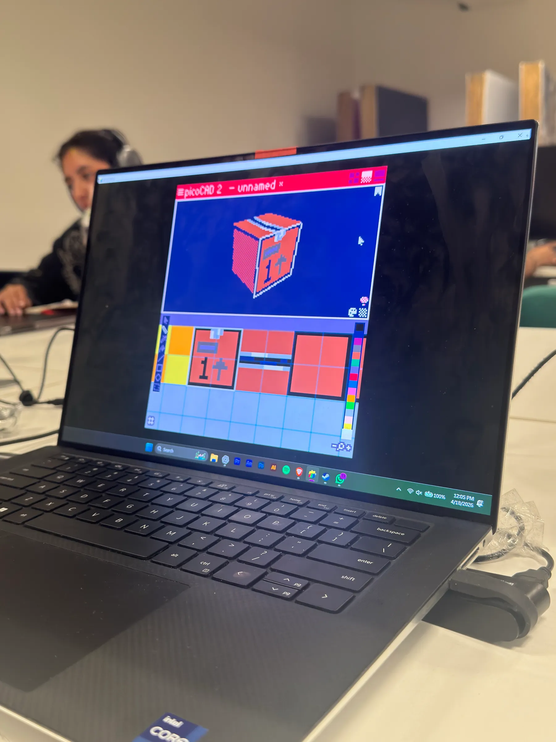 A laptop showing the pixel-art game 'Shift Happens' next to a water bottle with a 'Hack What Matters' sticker